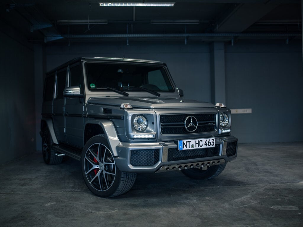 Silberner Mercedes G63 AMG -Geländewagen in Garage, mit auffälligen roten Bremssätteln.